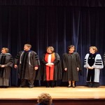 Variations of regalia on full display while faculty members wait to be honored